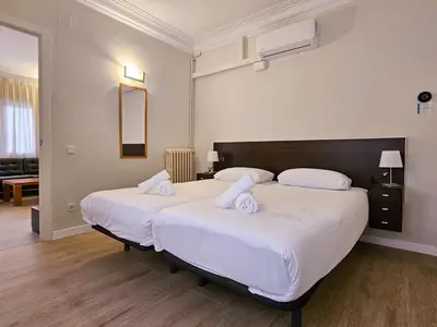 a bedroom with two beds with white sheets at Classbedroom Park Güell Apartment in Barcelona