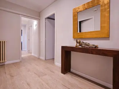 a room with a mirror and a statue on a counter at Classbedroom Park Güell Apartment in Barcelona