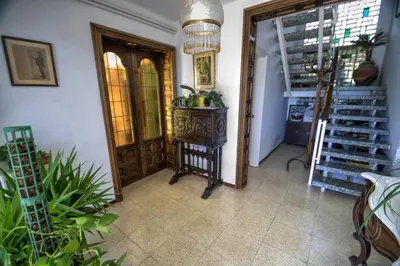 a hallway with a door and a table with plants at Can Ferran by Hello Homes Sitges in Sitges