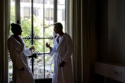 a man and a woman standing in front of a window at Praktik Rambla in Barcelona