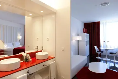 a bathroom with two sinks and a large mirror at Hotel Porta Fira 4* Sup in Hospitalet de Llobregat