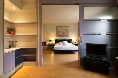 a room with a bedroom with a bed and a tv at Hotel Domo in Vilafranca del Penedès
