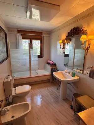 a bathroom with two sinks and a bath tub at Finca La Pedrera in Capellades