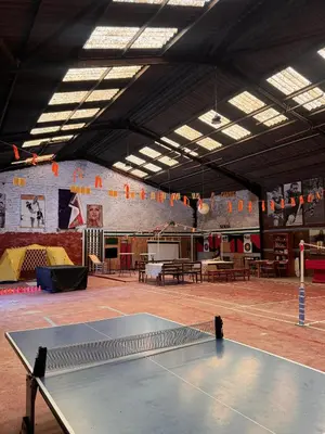 a ping pong table in a large room with a ping pong court at Finca La Pedrera in Capellades