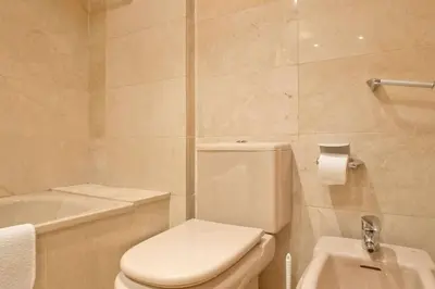 a bathroom with a white toilet and a sink at Comfortable 4 rooms 2Bath w balcony in Barcelona
