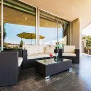 a living room with a couch and a table at Hotel Granollers in Granollers