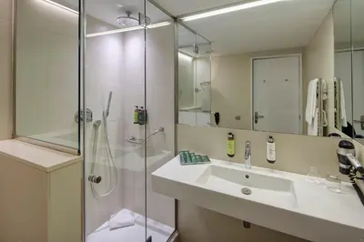 a bathroom with a sink and a shower at Sercotel Hotel Rosellon in Barcelona