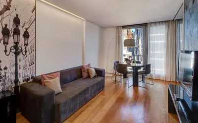 a living room with a couch and a table at Sercotel Hotel Rosellon in Barcelona