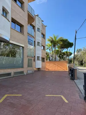 an empty parking lot in front of a building at Hotel 170 in Castelldefels