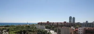 a view of a city with the ocean in the background at Hotel Best 4 Barcelona in Barcelona