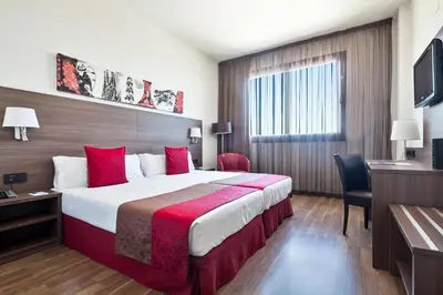 a hotel room with a large bed with red pillows at Hotel Best 4 Barcelona in Barcelona