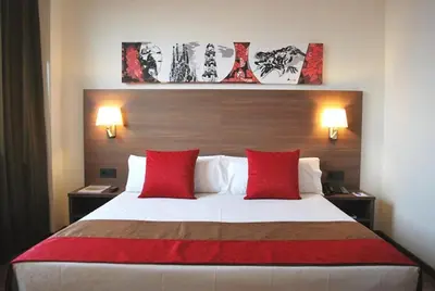 a hotel room with a large bed with red pillows at Hotel Best 4 Barcelona in Barcelona