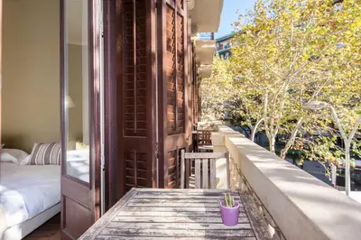 a balcony with a table and a view of a bedroom at Bailén Green House in Barcelona