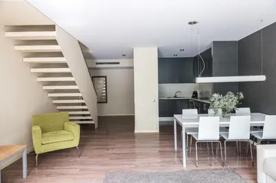 a kitchen and dining room with a white table and chairs at Casp 74 Apartments in Barcelona