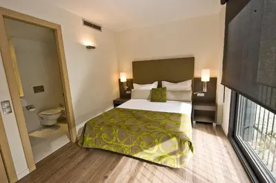 a hotel room with a bed and a toilet at Casp 74 Apartments in Barcelona