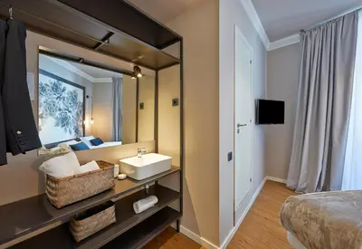 a bathroom with a sink and a bed and a mirror at Hostal Central Barcelona in Barcelona