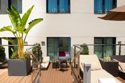 a balcony with a plant on a building at Grupotel Gran Via 678 in Barcelona