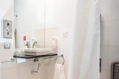 a bathroom with a sink and a shower curtain at Holiday Inn Express Sant Cugat by IHG in Sant Cugat del Vallès
