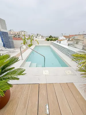 a swimming pool on the roof of a building at Alenti Sitges Hotel in Sitges