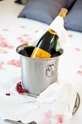 a bottle of wine in a bucket on a table at Alenti Sitges Hotel in Sitges