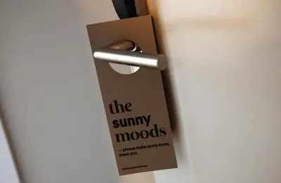 a door with a card on the handle of a door at The Moods Catedral Hostal Boutique in Barcelona