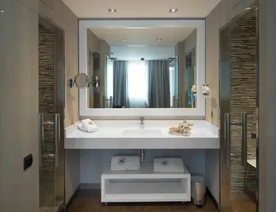 a bathroom with a sink and a large mirror at Catalonia Catedral in Barcelona