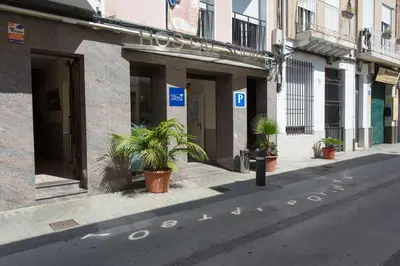 a street with potted plants on the side of a building at Hostal Solimar in Badalona