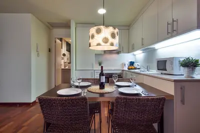 a kitchen with a table with a bottle of wine at Inside Barcelona Apartments Esparteria in Barcelona