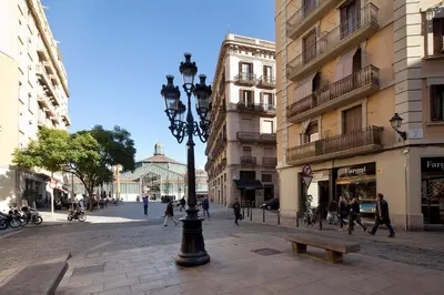 a street light and a bench on a city street at Inside Barcelona Apartments Esparteria in Barcelona