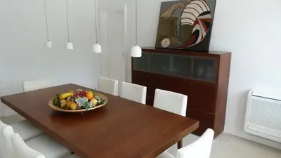 a dining room table with a bowl of fruit on it at Luxury Beach House in Sitges