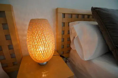 a lamp sitting on a table next to a bed at Luxury Beach House in Sitges