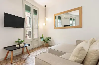 a living room with a couch and a mirror at Ola Living Santa Anna in Barcelona