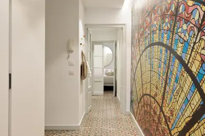 a hallway with a colorful painting on the wall at Ola Living Santa Anna in Barcelona