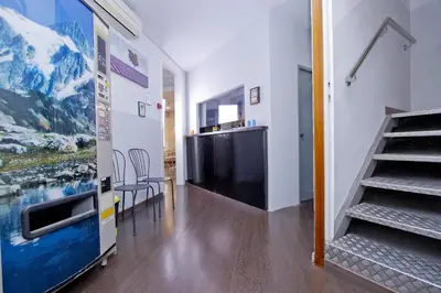 a hallway with a staircase and a table and chairs at Barcelona City Hotel in Barcelona
