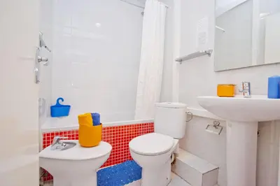 a white bathroom with a toilet and a sink at Barcelona City Hotel in Barcelona
