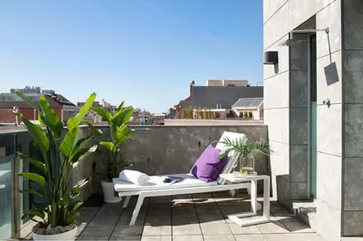 a balcony with a bench and plants on a building at Allegro Barcelona in Barcelona