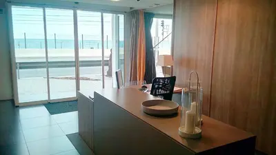a kitchen with a desk with a view of the ocean at Vila De Premiá in Premiá de Mar