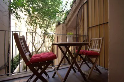 two chairs and a table on a balcony at Charm Rambla Catalunya in Barcelona