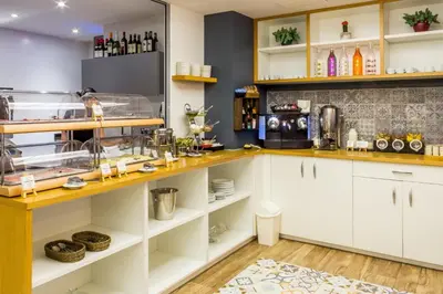 a kitchen with white cabinets and a counter at Hostemplo Sagrada Familia in Barcelona