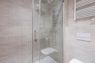 a bathroom with a glass shower with a toilet at Tango in Sitges