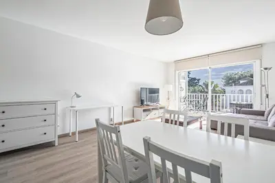 a kitchen and living room with a table and chairs at Tango in Sitges