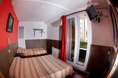 a small room with two beds and a window at Be Ramblas Guest House in Barcelona