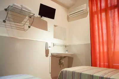 a small room with a sink and a bed at Be Ramblas Guest House in Barcelona