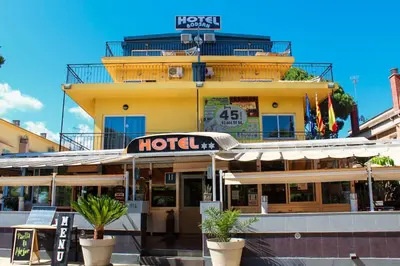 a hotel building with plants in front of it at Hotel Rodsan Suizo in Castelldefels