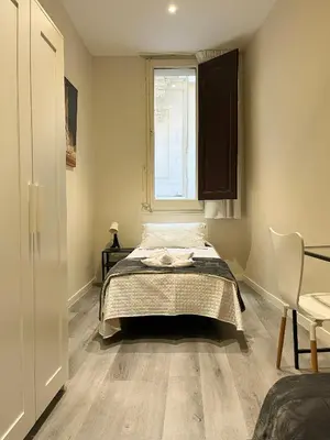 a bedroom with a bed and a window at Barcelona City Ramblas in Barcelona