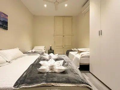 a bedroom with three beds and a closet at Barcelona City Ramblas in Barcelona