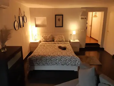 a bedroom with a bed and two tables and two lamps at The Hipstel Parallel in Barcelona