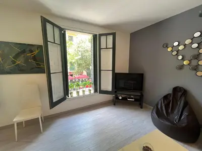 a living room with a tv and a window at Barcelona 54 Apartment Rentals in Barcelona