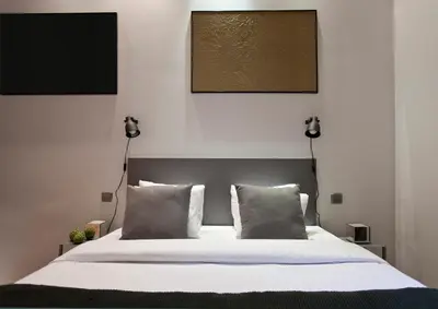 a bedroom with a large bed with two pillows at Centric Gracia Apartments in Barcelona