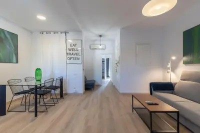 a living room with a couch and a table at Centric Gracia Apartments in Barcelona